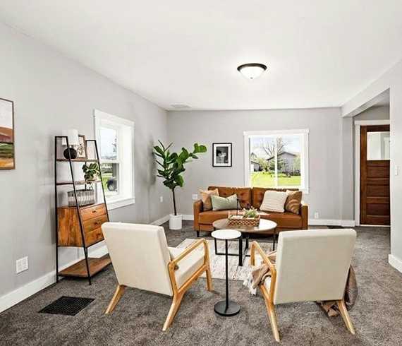 Sitting area staged with chairs, couch and home decor